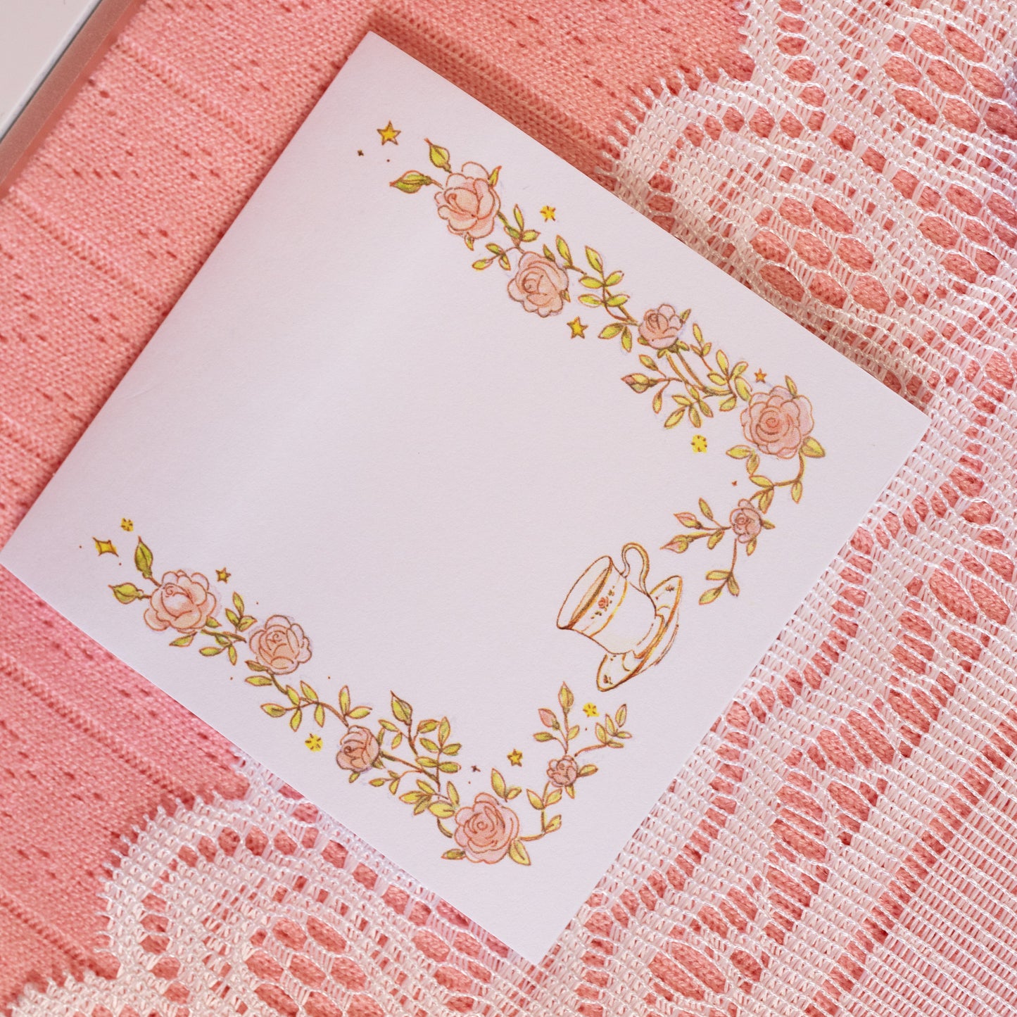 greenery and pink flowers with tea cup