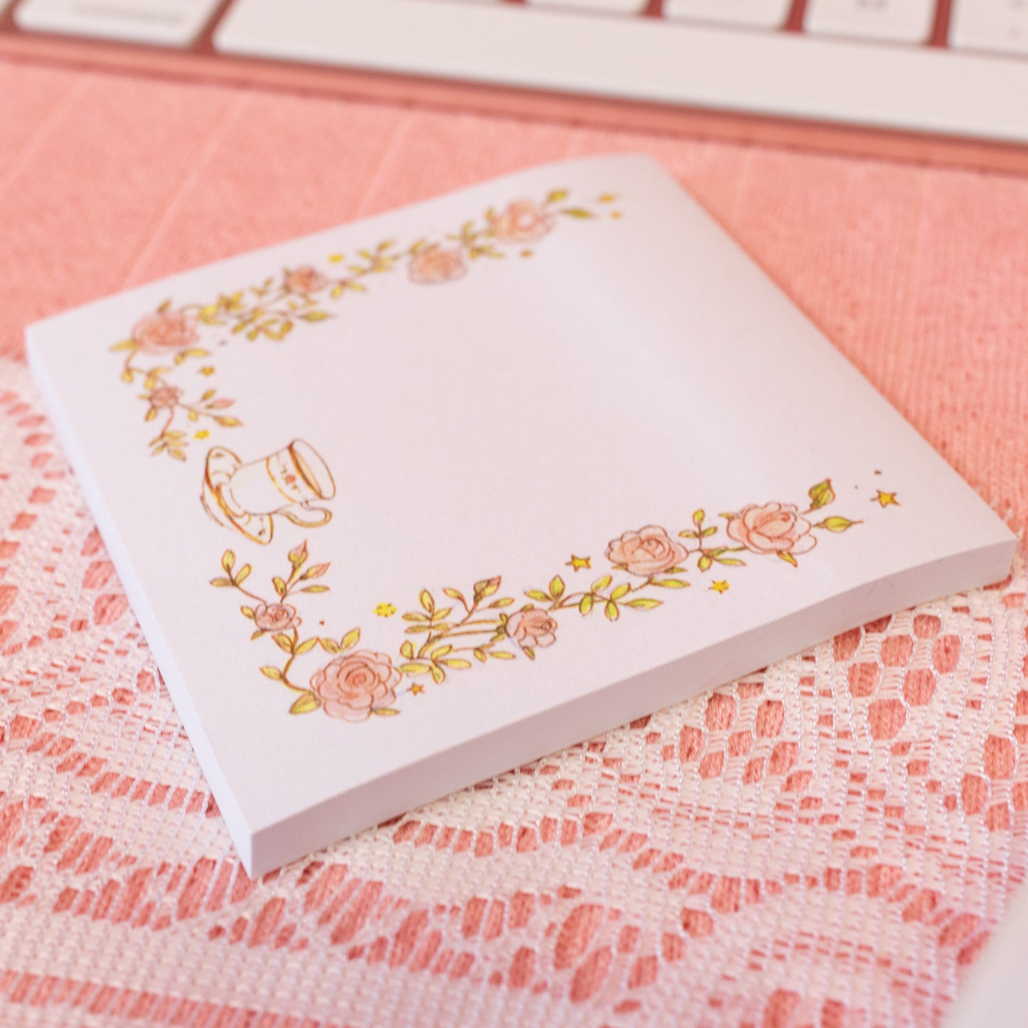 pink flowers and tea cup on white sticky note