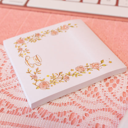 pink flowers and tea cup on white sticky note