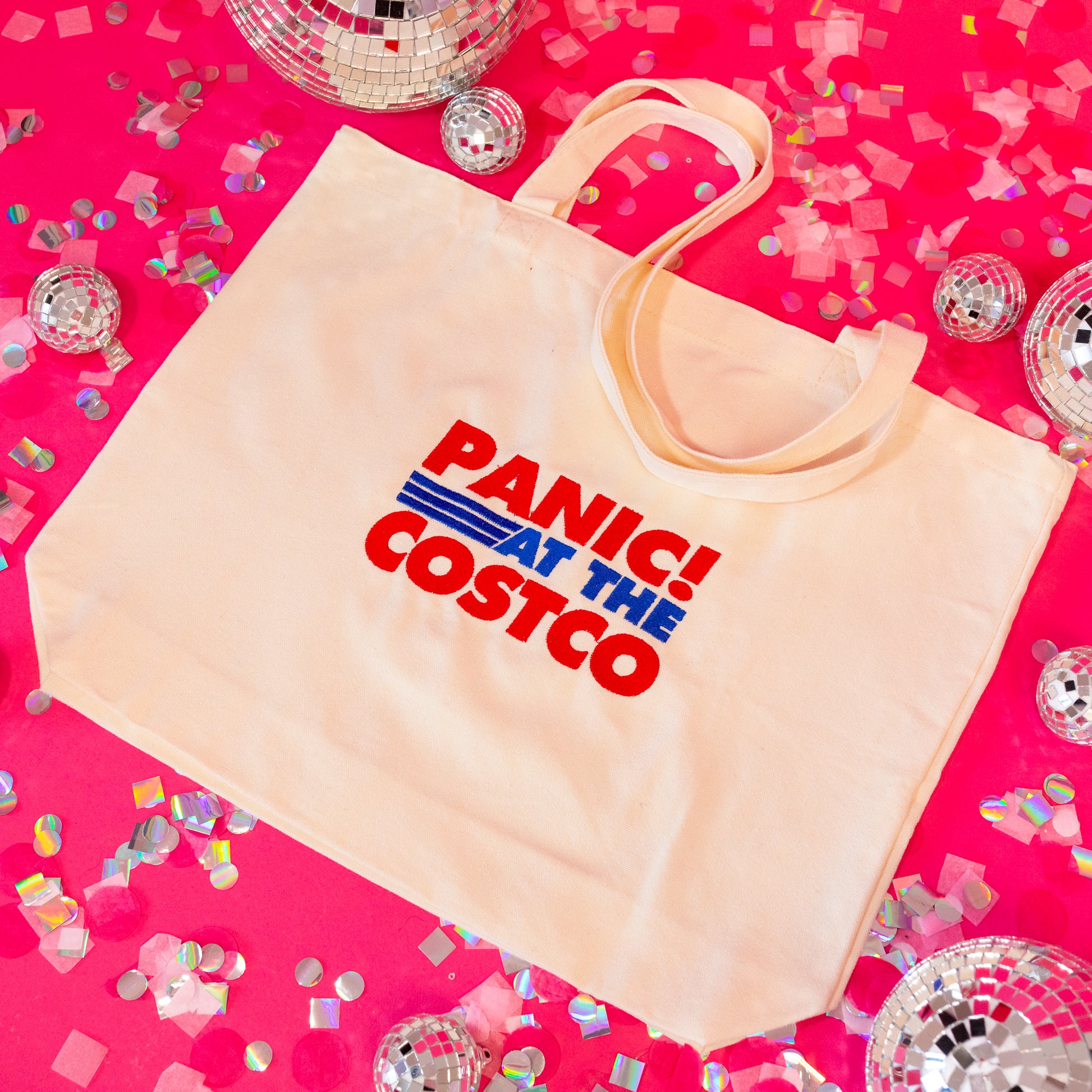 beige tote bag with red and blue lettering