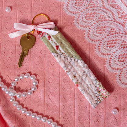 green and pink keychain with red florals