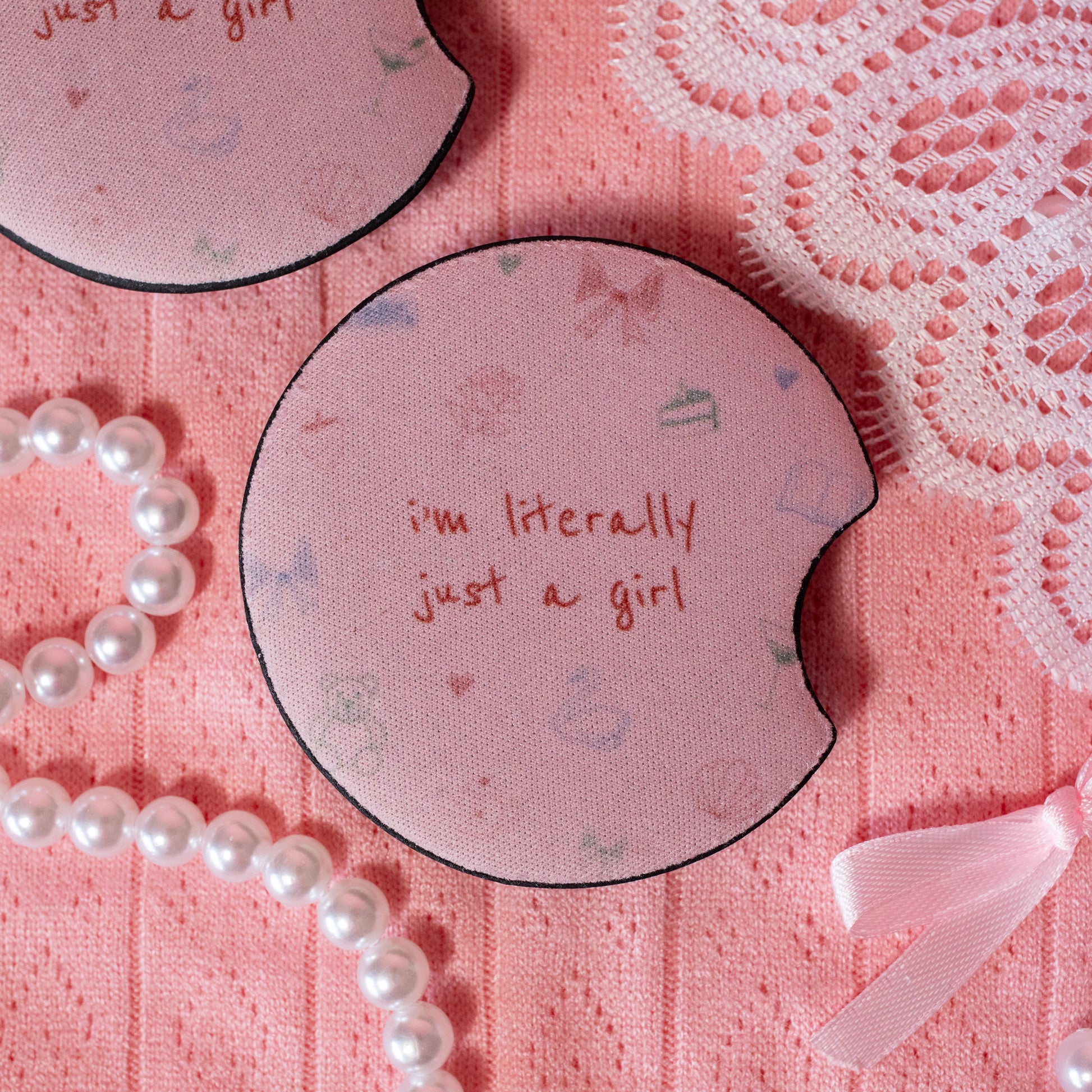 pink coaster with pink bows, green cakes, hearts, teddy bears, seashells and swans