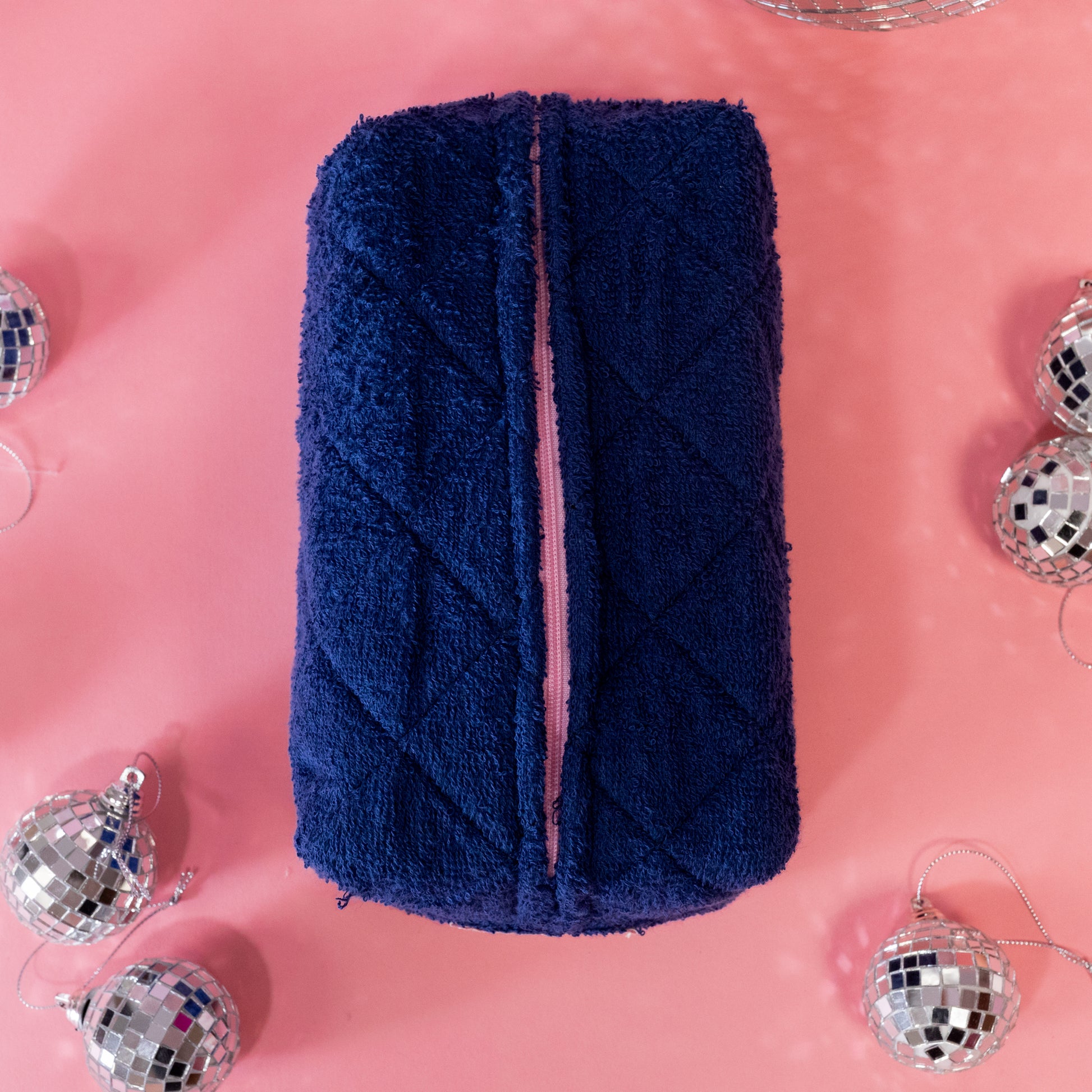 pink zipper on blue makeup bag