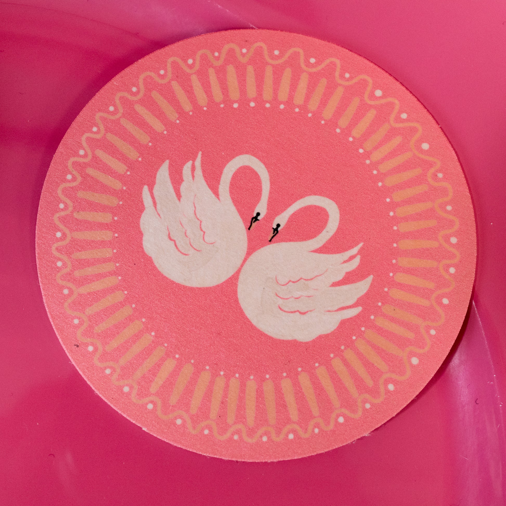 white and pink swan coaster