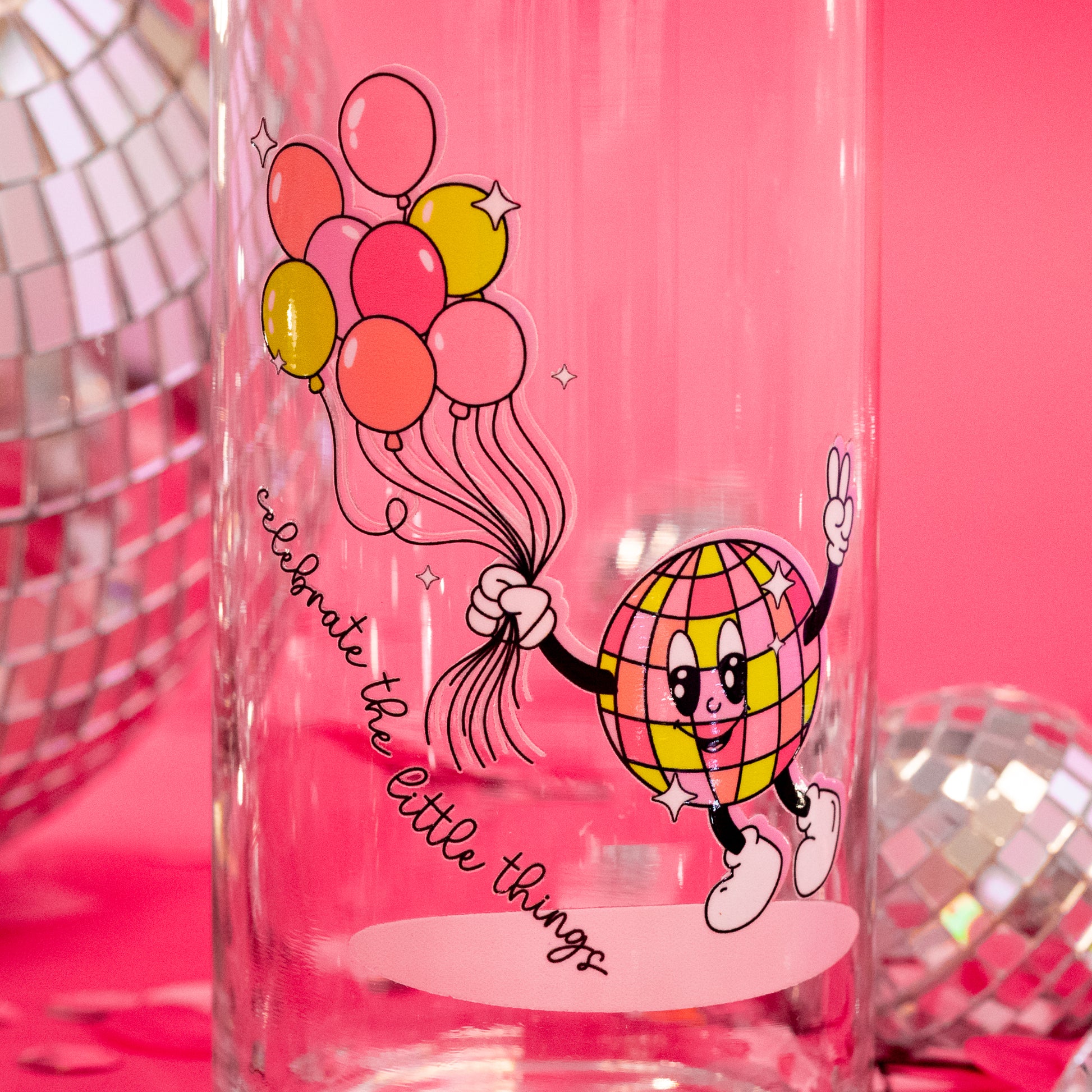 beer can glass with pink, yellow, and orange deisgn
