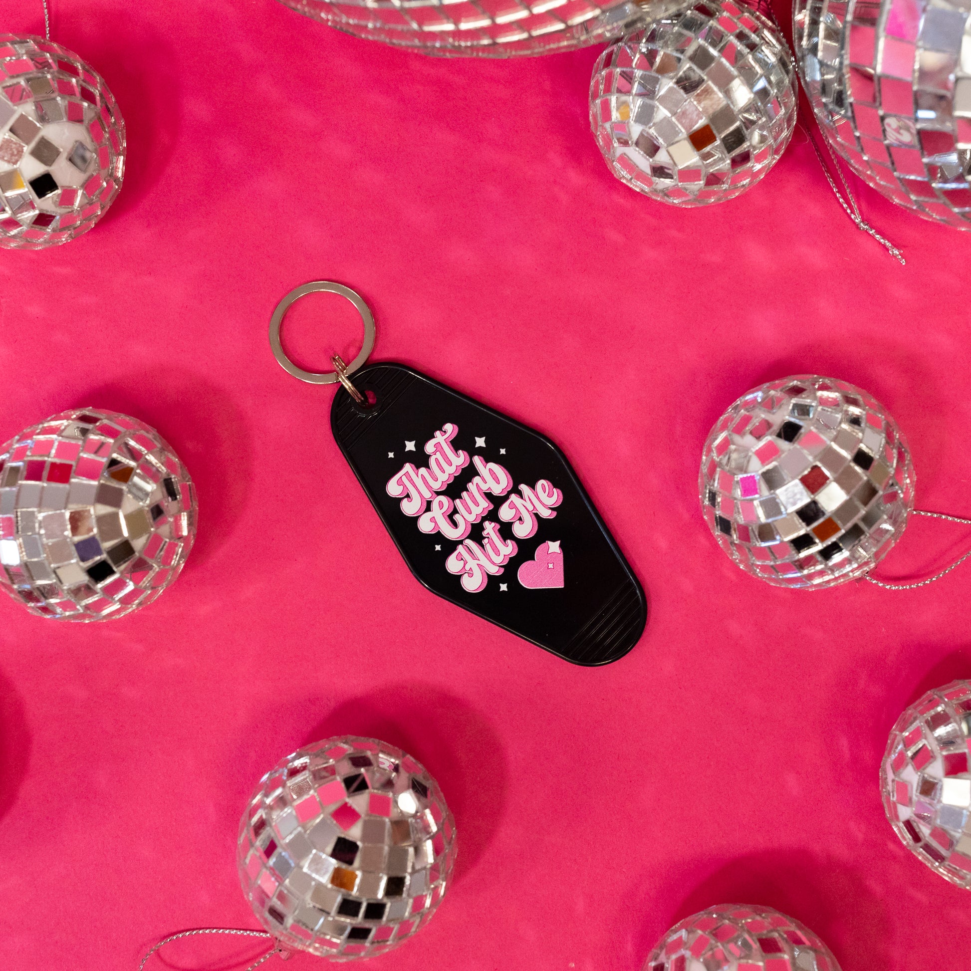 black motel keychain with pink and white lettering