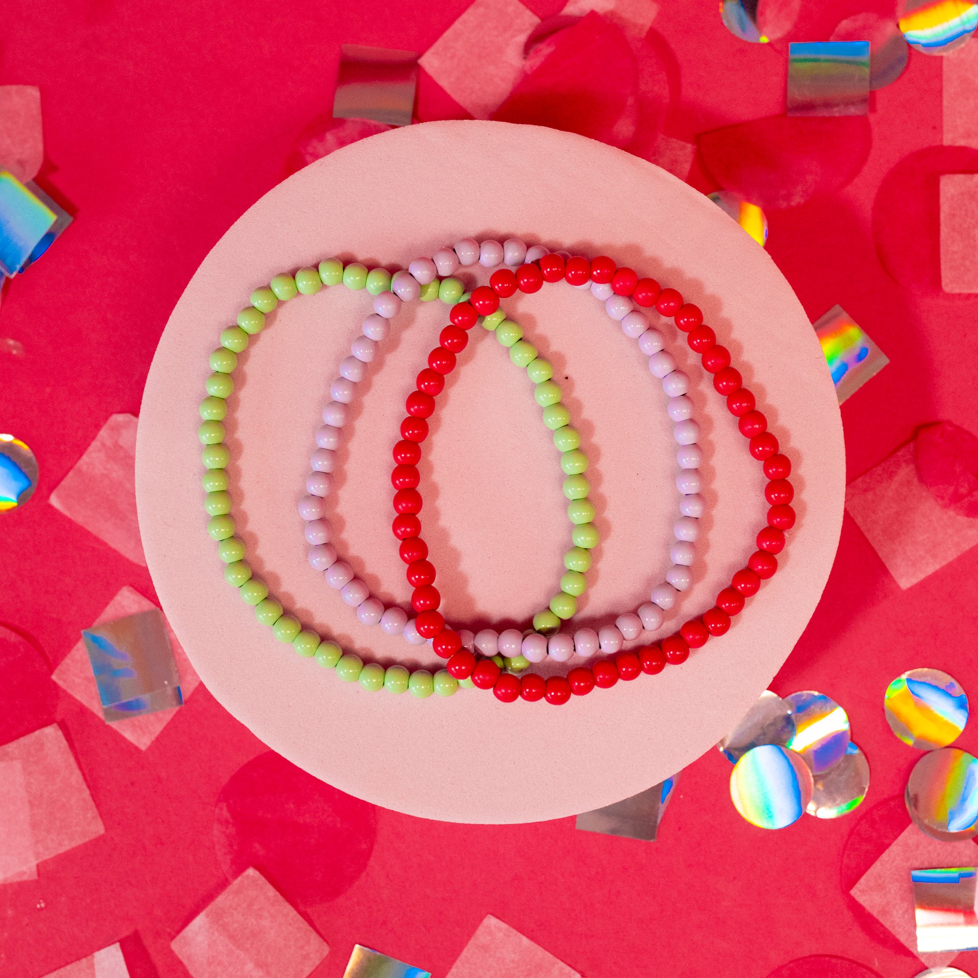 red, pink and green beaded bracelets
