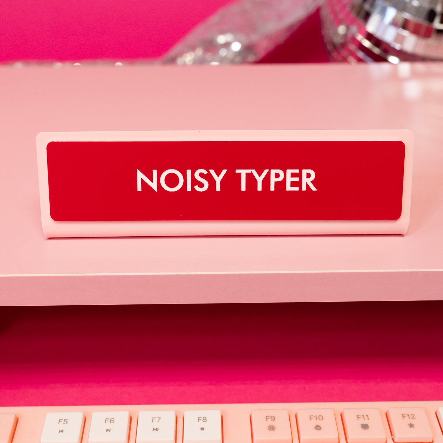 red and white noisy typer desk sign
