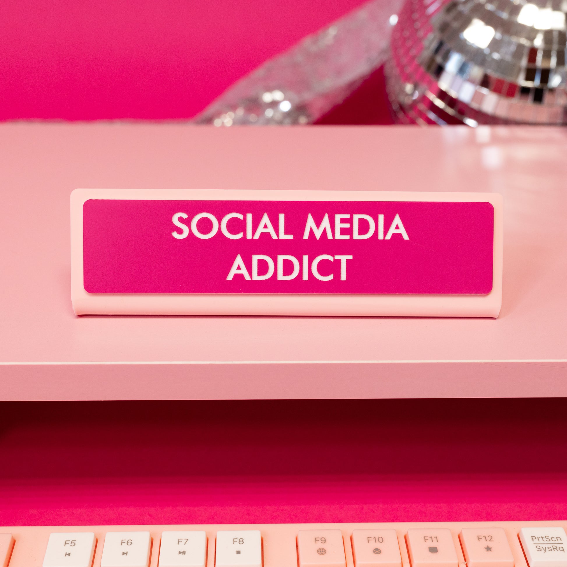 social media addict pink and white desk sign
