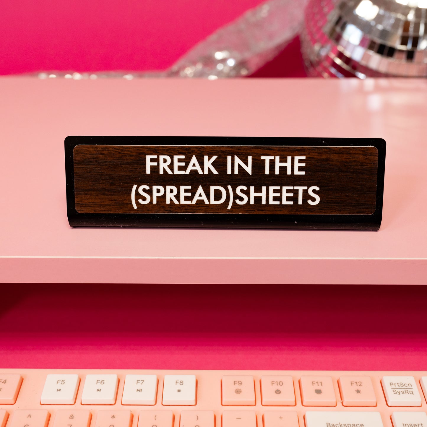 freak in the spreadsheet brown and black desk sign