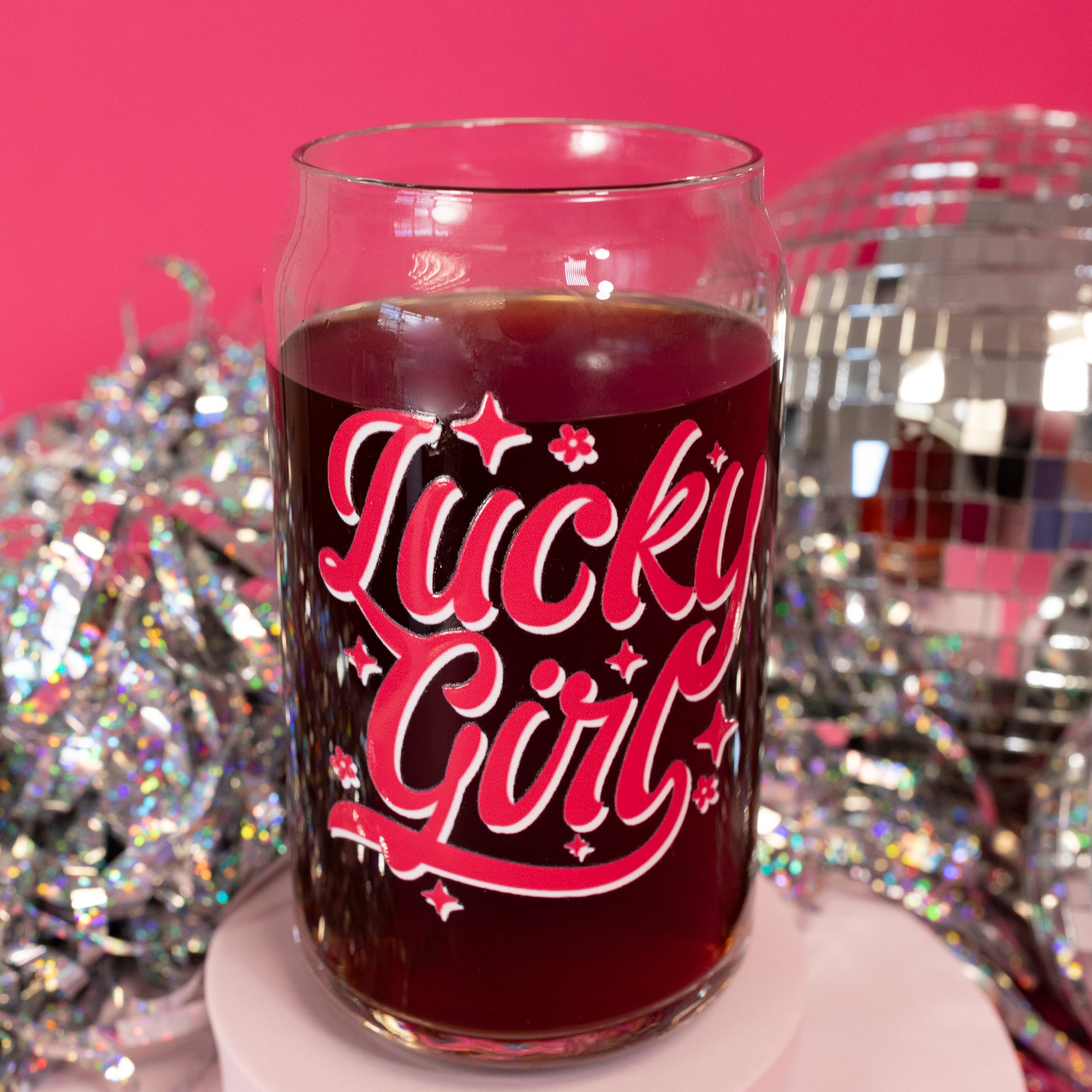 clear beer can glass with pink and white lettering