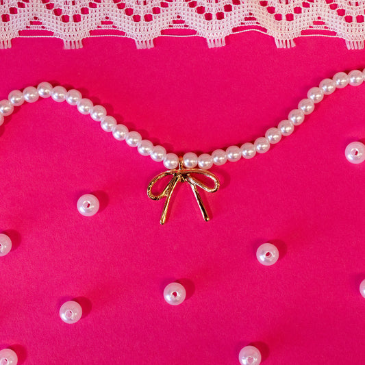 pearl necklace with gold bow