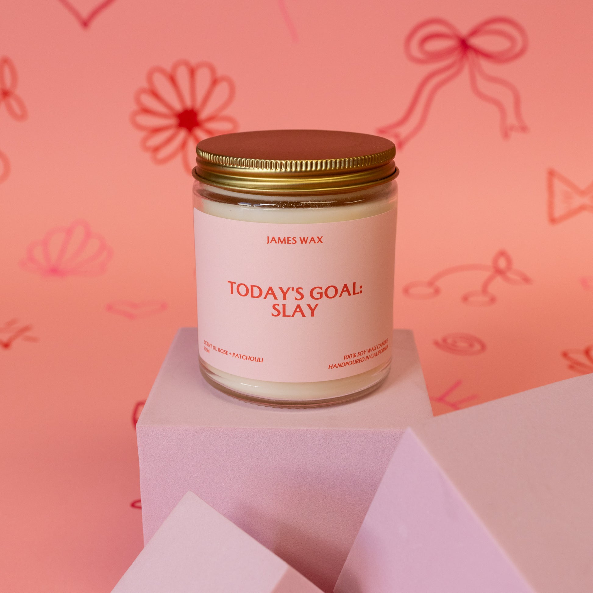 pink jar candle with red words