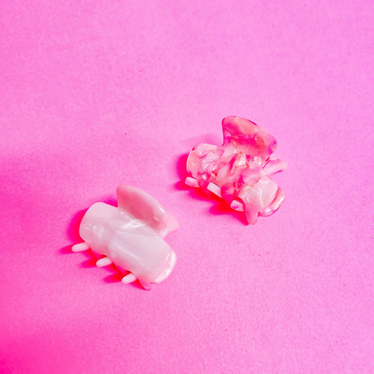 Pink and white 1 inch marble claw clips.