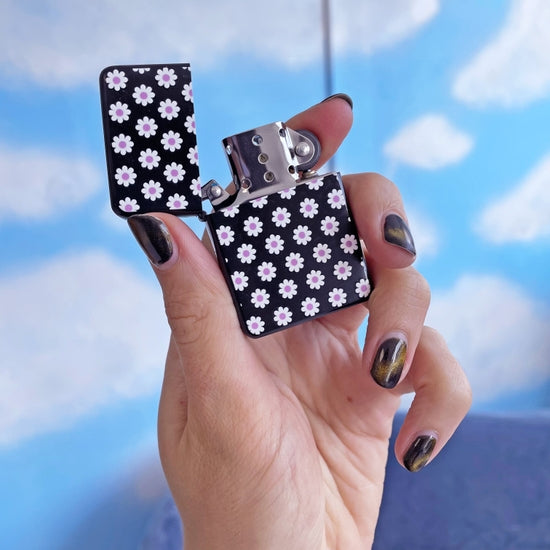 Girly refillable zippo lighter with daisy graphic.